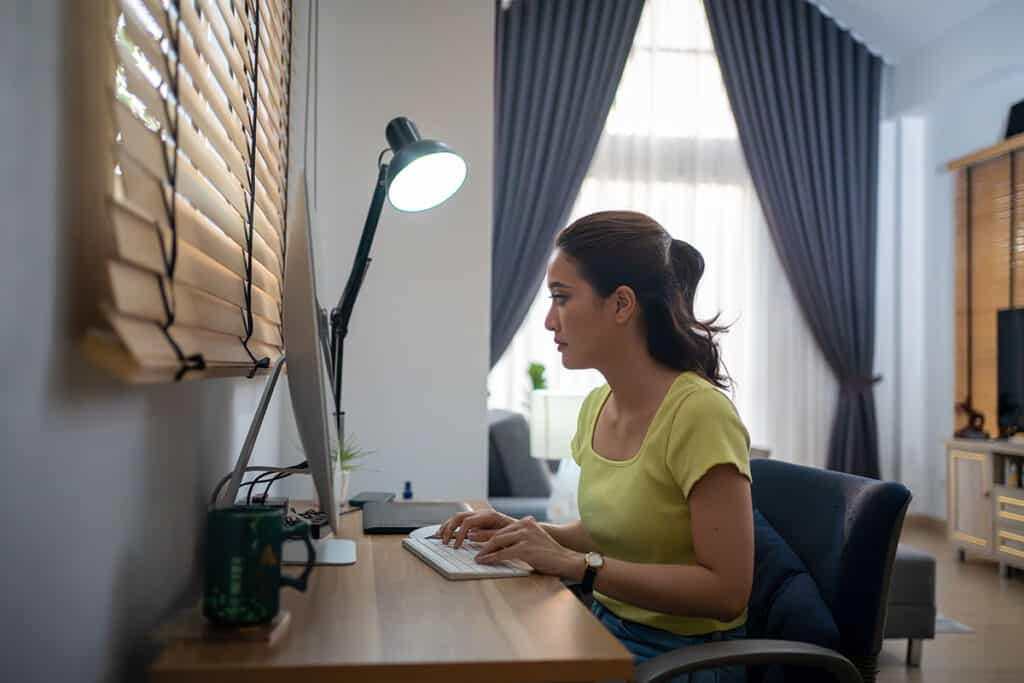 Women affiliate marketer using writing skills on her laptop
